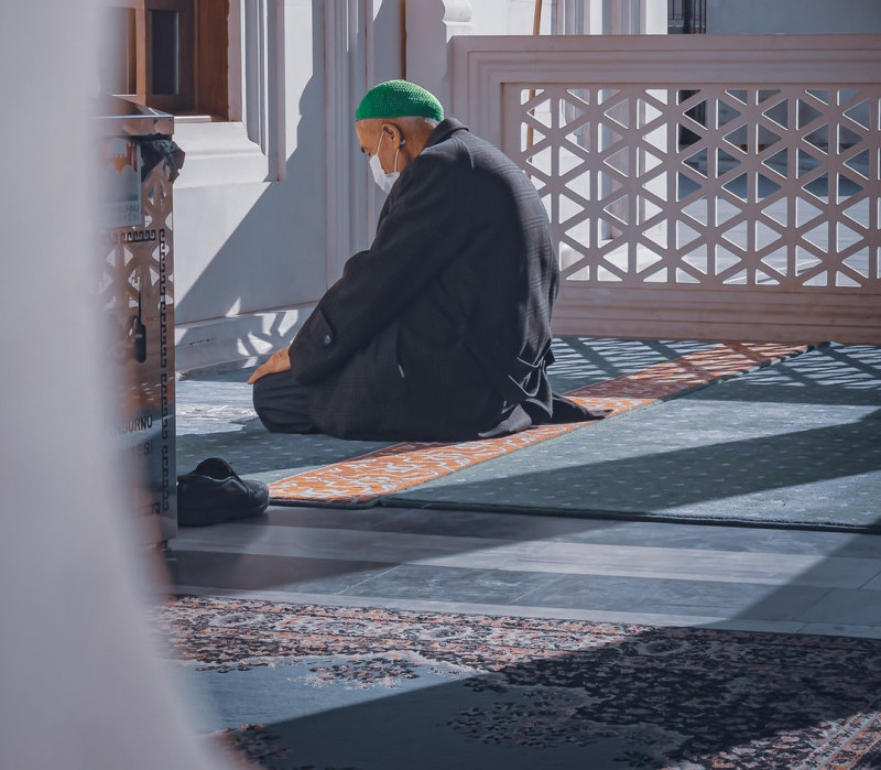 man praying in mosque