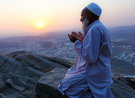 man praying on hill